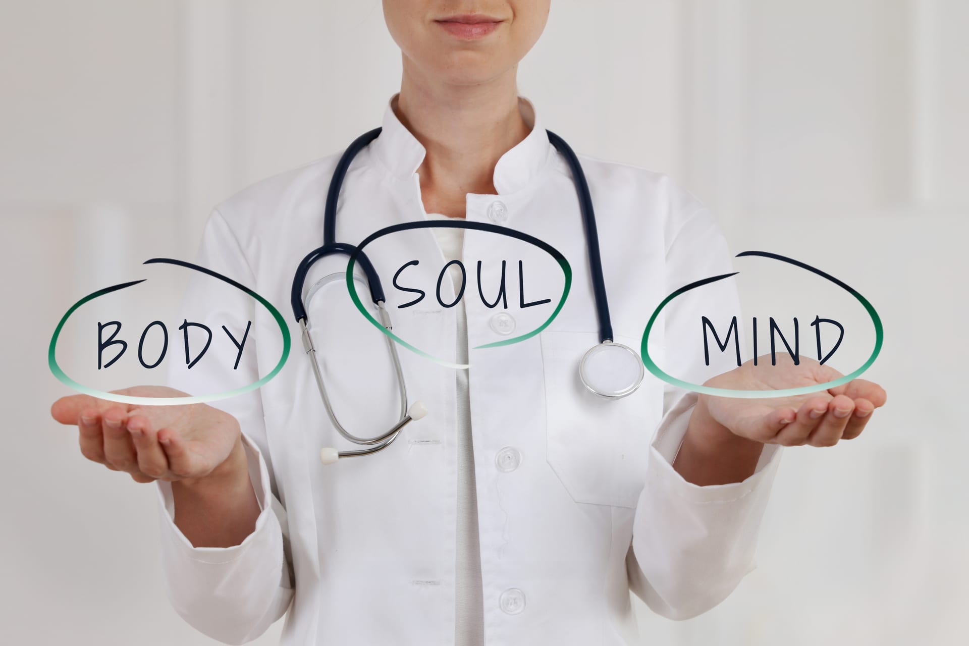 Practitioner holding the words Body, Soul, and Mind — a whole-person approach to healing
